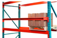 Red and blue metal shelving unit with cardboard boxes on a white background